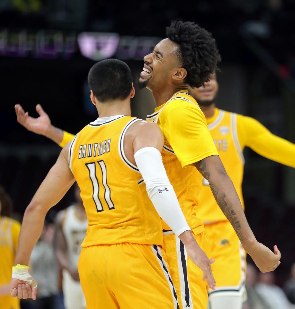 Kent State's Julius Rollins (0) and guard Giovanni Santiago (11) celebrate after the Golden Flashes upset top seed Toledo in the quarterfinals of the Mid-American Conference Tournament on Thursday in Cleveland.