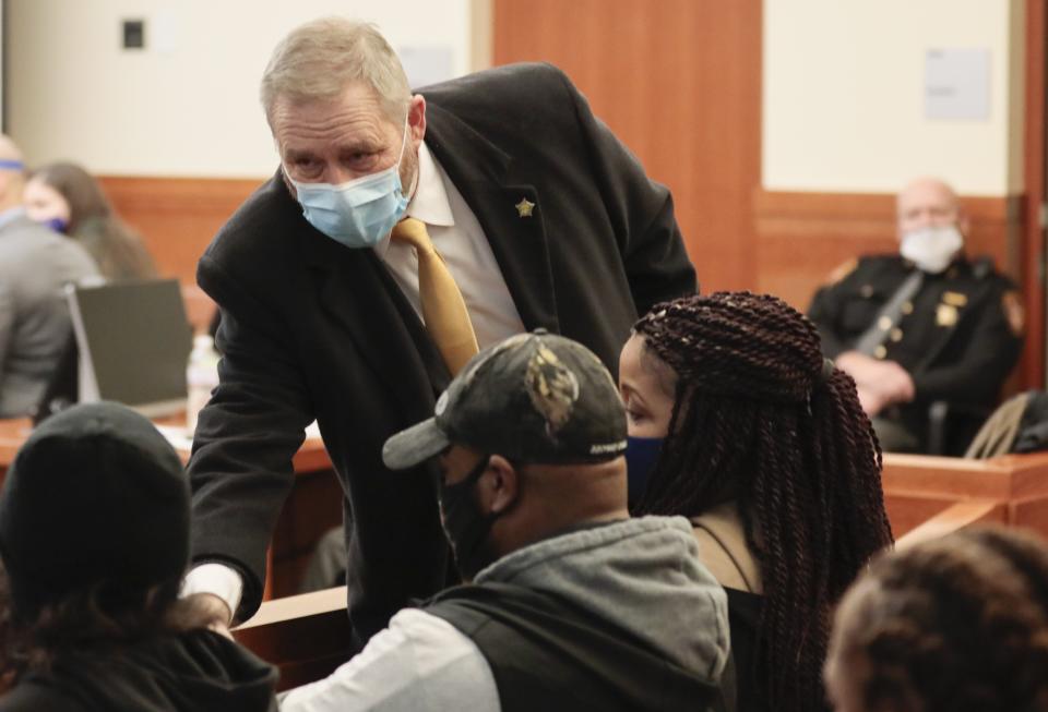 Ohio Attorney General Dave Yost, center, introduces himself to the family of Andre Hill before the start of former Columbus police officer Adam Coy’s initial appearance on Friday, Feb. 5, 2021 at the Franklin County Common Pleas Courthouse in Columbus, Ohio. Coy was arraigned on four charges in the December 2020 police shooting death of Andre Hill, a Black man. Coy was charged with one count of murder, one count of felonious assault and two counts of dereliction of duty, one of which was for failure to render aid to Hill after he was shot. His bond was set at $3 million. Yost’s office was appointed special prosecutor in the case.