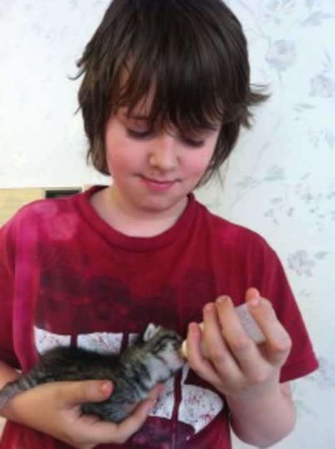 Maxwell feeds his kitten, Steve, with a bottle. Steve, who is female, is named after a Minecraft character.