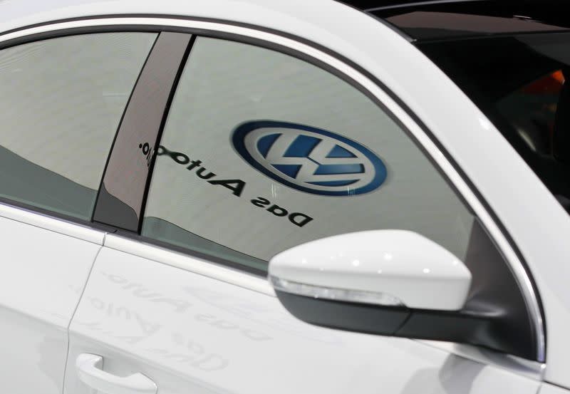 The Volkwagen logo is seen reflected on the window of the newly-designed 2013 Volkswagen CC at the LA Auto Show in Los Angeles