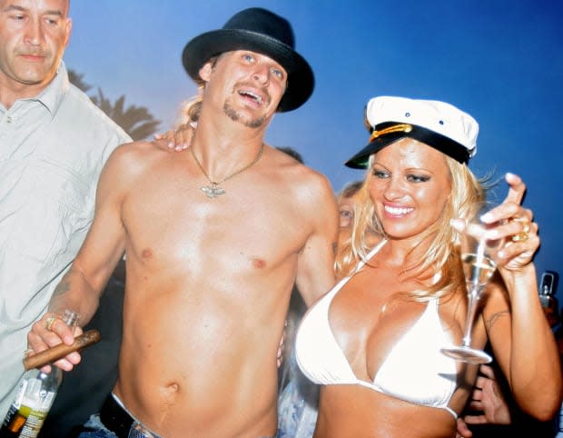 Pamela Anderson shares a drink with Kid Rock on their wedding day at the beach in Saint-Tropez, Southern France, on July 29, 2006.<p><a href="https://www.gettyimages.com/detail/71538317" rel="nofollow noopener" target="_blank" data-ylk="slk:ERIC ESTRADE/Getty Images;elm:context_link;itc:0;sec:content-canvas" class="link ">ERIC ESTRADE/Getty Images</a></p>