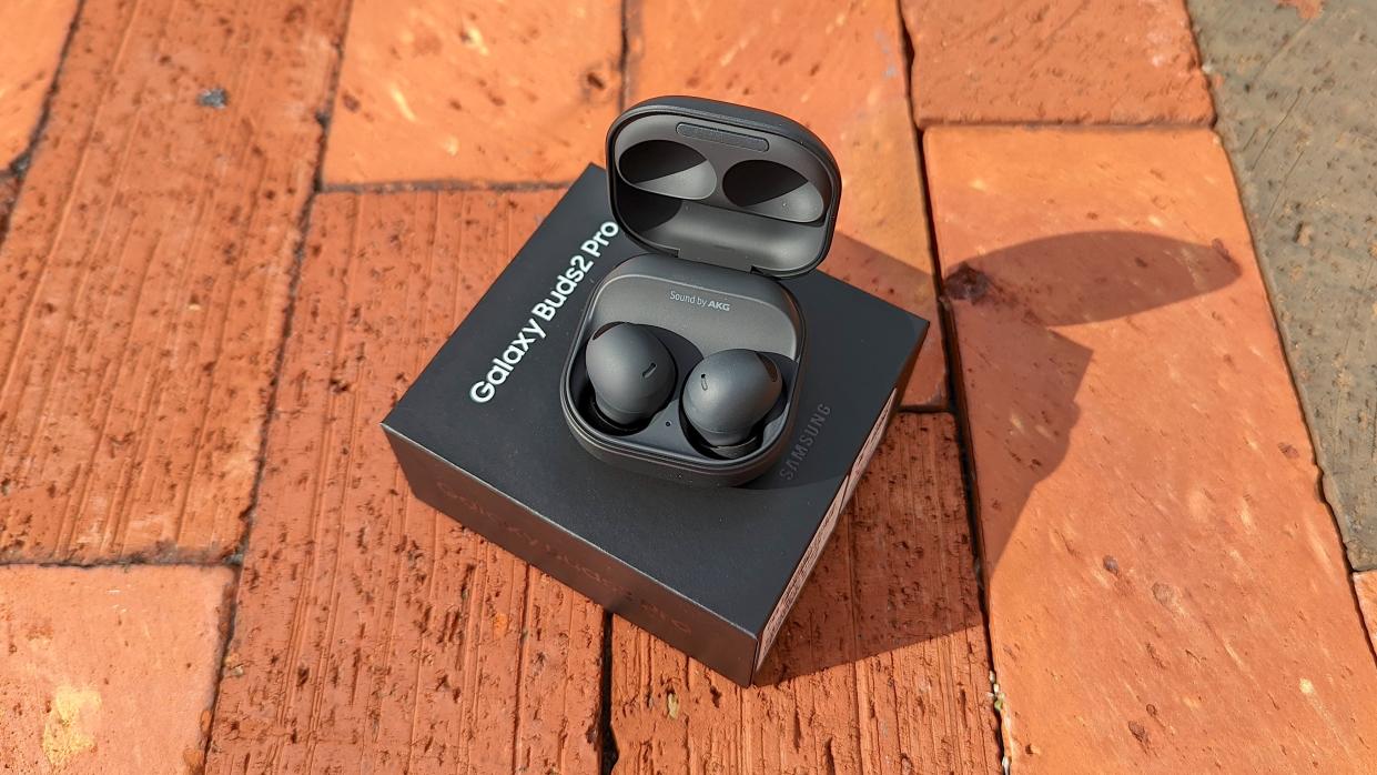  The Samsung Galaxy Buds 2 Pro unboxed and displayed atop an exposed brick surface. 