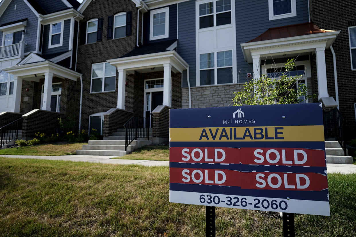 An advertising sign for building land stands in front of a new home construction site in Northbrook, Ill., Wednesday, June 23, 2021, as the housing market rebounds and mortgage rates remain low. (AP Photo/Nam Y. Huh)