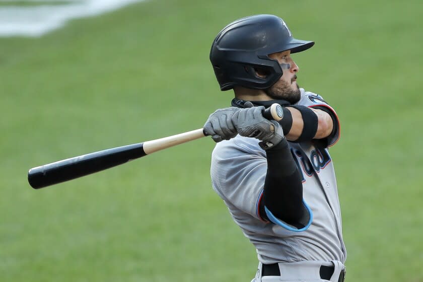 The Olympic rings are seen on the knob of Miami Marlins&#39; Eddy Alvarez&#39;s bat as he swings at a pitch from the Baltimore Orioles during the seventh inning in the first game of a baseball doubleheader, Wednesday, Aug. 5, 2020, in Baltimore. Among the Marlins&#39; roster replacements following their coronavirus outbreak was infielder Alvarez, a 2014 Olympic silver medalist in speedskating. (AP Photo/Julio Cortez)