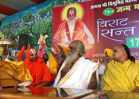 Nritya Gopal Das (C), a Hindu priest and chairman of Shri Ram Janam Bhoomi Nyas, a trust that is committed to building a Ram temple at a disputed religious site, attends his birthday celebration ceremony in Ayodhya in the northern state of Uttar Pradesh, India, June 17, 2016. REUTERS/Rupam Jain