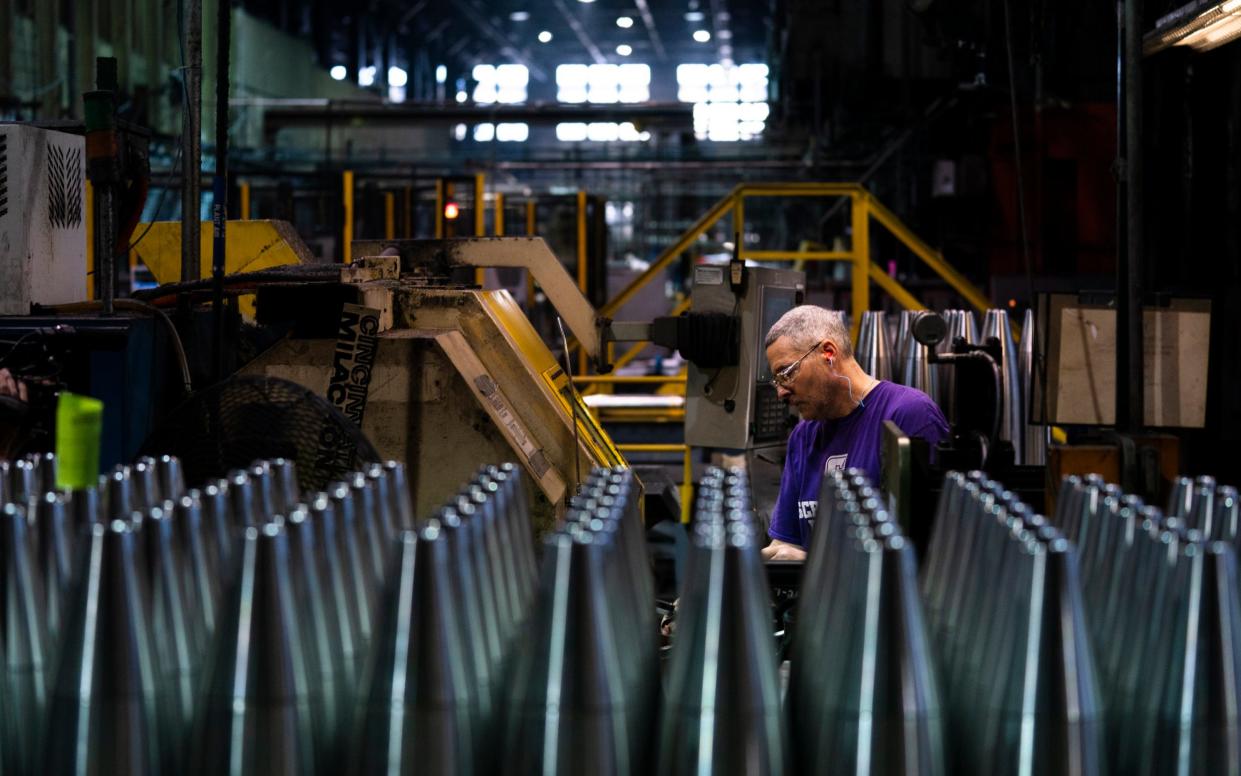 A steel worker manufactures 155 mm M795 artillery projectiles at the Scranton Army Ammunition Plant in Scranton