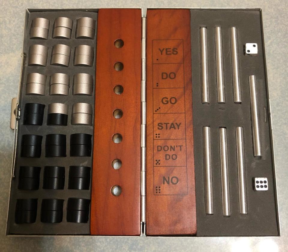 game pieces with a wooden board with the words, yes, do, go, stay, don't go, no