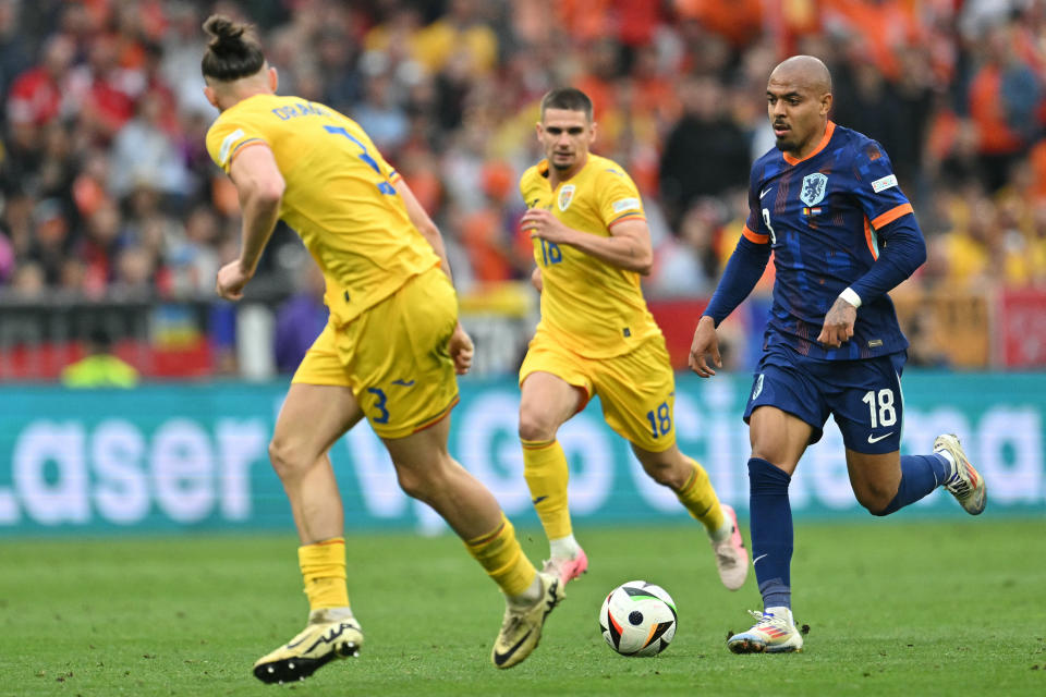 Romania's defender #03 Radu Dragusin marks Netherlands' forward #18 Donyell Malen during the UEFA Euro 2024 round of 16 football match between Romania and the Netherlands at the Munich Football Arena in Munich on July 2, 2024. (Photo by MIGUEL MEDINA / AFP) (Photo by MIGUEL MEDINA/AFP via Getty Images)