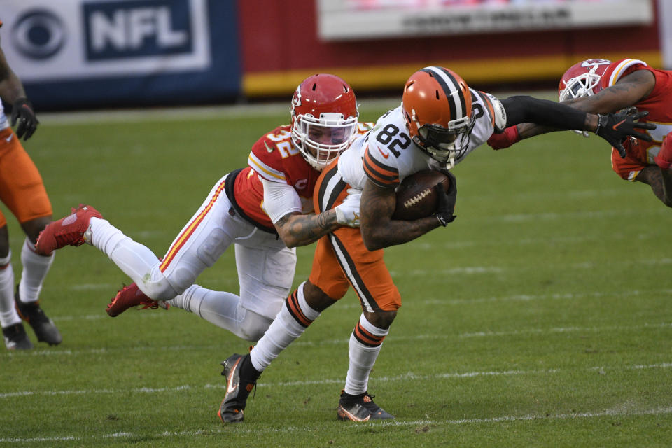 Cleveland Browns wide receiver Rashard Higgins (82) is tackled by Kansas City Chiefs safety Tyrann Mathieu (32) after catching a pass during the second half of an NFL divisional round football game, Sunday, Jan. 17, 2021, in Kansas City. The Chiefs won 22-17. (AP Photo/Reed Hoffmann)