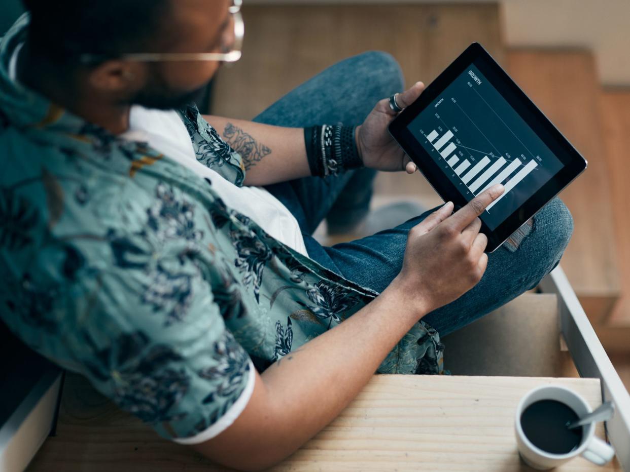 Young millennial using technology for his investment and on line banking.