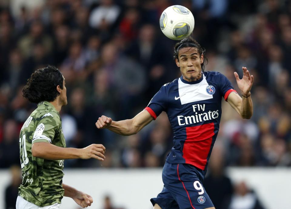 Paris St Germain's Cavani challenges Bastia's Modesto during their French Ligue 1 soccer match in Paris