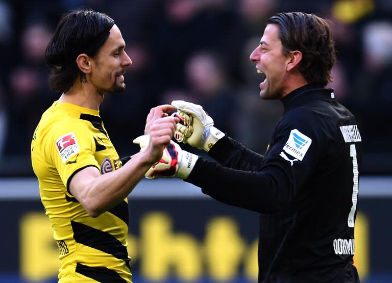 Dortmund's goalkeeper Roman Weidenfeller (R) and defender Neven Subotic celebrate after their German first division Bundesliga match against Schalke 04, in Dortmund, western Germany, on February 28, 2015