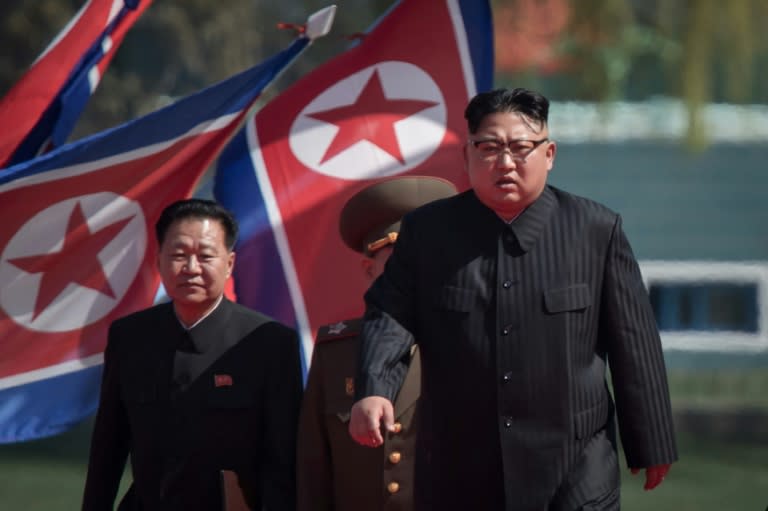 North Korean leader Kim Jong-Un (right) arrives at an opening ceremony for 'Rymoyong street', a new housing development in Pyongyang on April 13, 2017