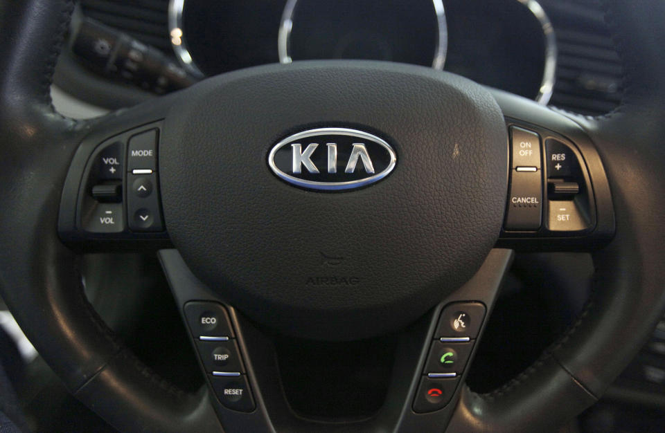 FILE- This Oct. 5, 2012, file photo, shows a Kia optima's steering wheel inside of a Kia car dealership in Elmhurst, Ill. Nearly 3.4 million Hyundai and Kia vehicles in the U.S. are under recall due to the risk of engine compartment fires. (AP Photo/Nam Y. Huh, File)