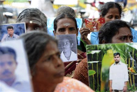 Sri Lankan Tamils hold pictures of family members who disappeared during the war against the Liberation Tigers of Tamil Eelam (LTTE) at a protest in Jaffna, about 400 km (250 miles) north of Colombo November 15, 2013. REUTERS/Stringer