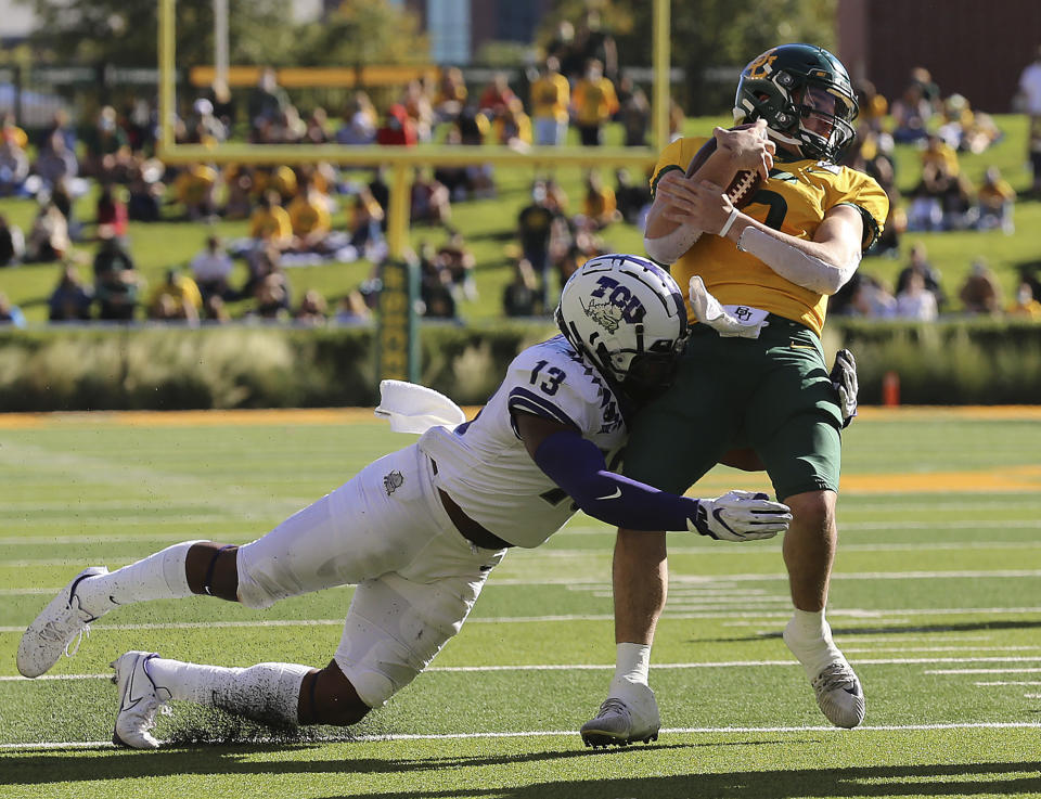 Baylor quarterback Charlie Brewer (5) is tackled by TCU linebacker Dee Winters (13) during the first half of an NCAA college football game in Waco, Texas, Saturday, Oct. 31, 2020. (Jerry Larson/Waco Tribune-Herald via AP)