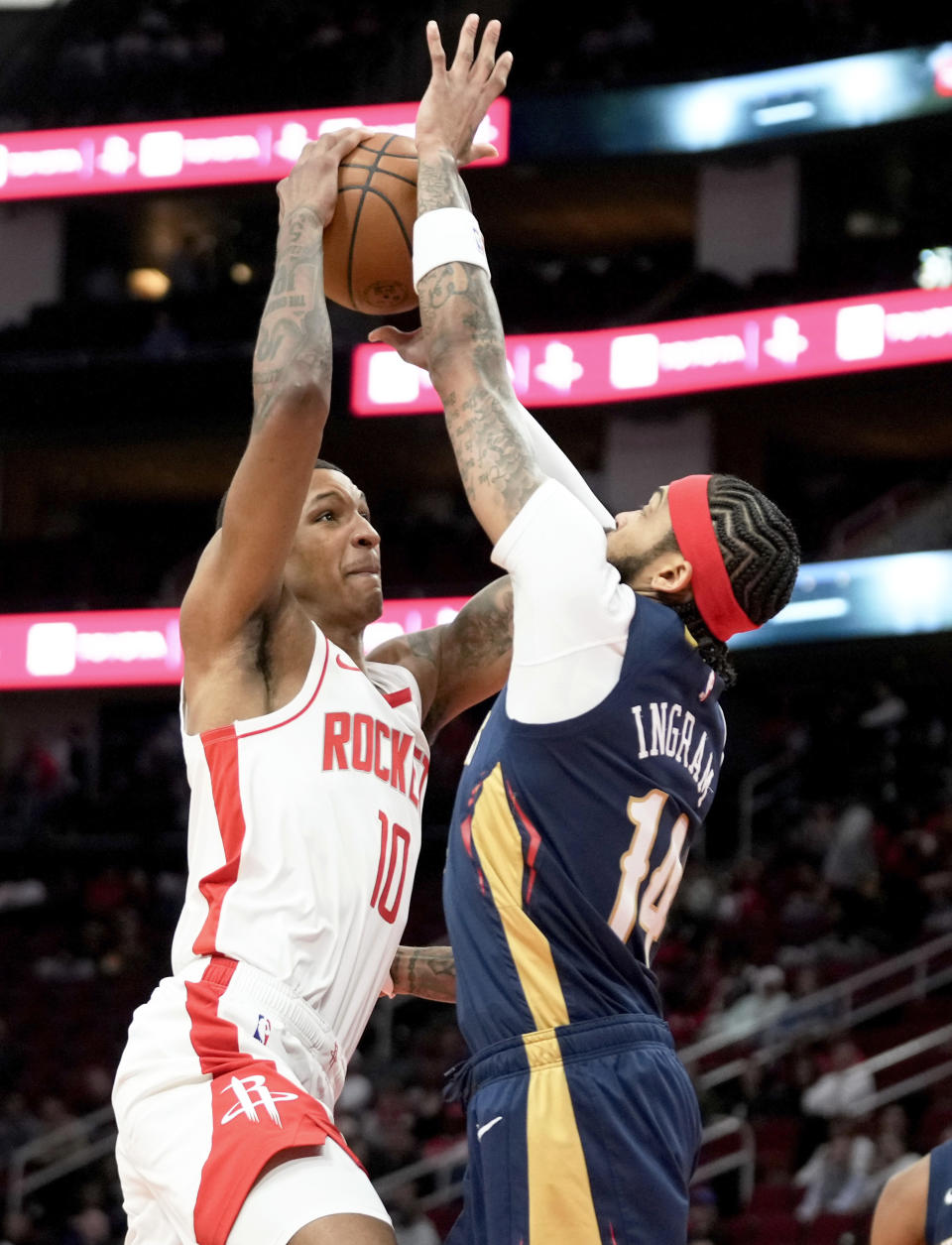 Houston Rockets forward Jabari Smith Jr. (10) shoots as New Orleans Pelicans forward Brandon Ingram defends during the first half of an NBA basketball game Wednesday, Jan. 31, 2024, in Houston. (AP Photo/Eric Christian Smith)