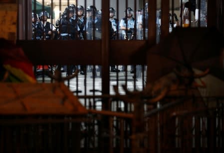 A barricade set by anti-extradition demonstrators is seen in front of Central Police Station with police officers inside, after a march to call for democratic reforms in Hong Kong