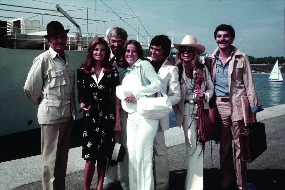 An image from The Last of Sheila shows the cast of the Last of Sheila standing in front of a boat
