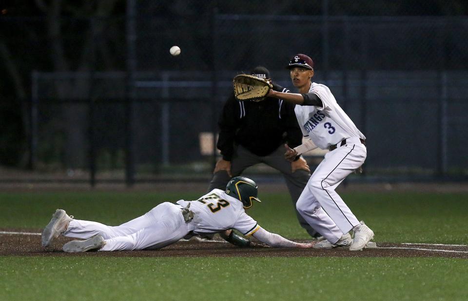 Salina Central Devante Keim-Owens (3) looks to tag out Salina South's Garrett Aills (23) during their game Tuesday, April 26, 2022, at Dean Evans Stadium. South defeated Central 10-3. 