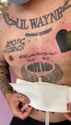 Man with more than 20 tattoos adds to his collection as he pops the question to his girlfriend with tattoo that reads "Will you marry me?" - complete with 'Yes/No' tick-boxes