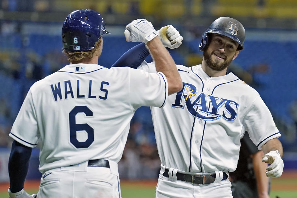 Tampa Bay Rays' Brandon Lowe celebrates his two-run home run off Baltimore Orioles starting pitcher Keegan Akin with Taylor Walls (6) during the fourth inning of a baseball game Friday, June 11, 2021, in St. Petersburg, Fla. (AP Photo/Chris O'Meara)