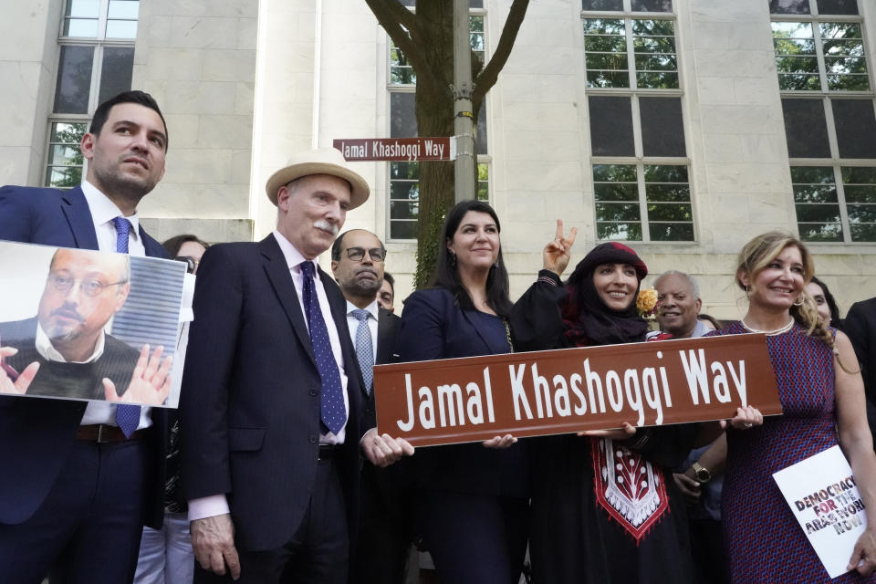Participants stand for a group photo after unveiling a new street sign for Jamal Khashoggi Way outside of the Embassy of Saudi Arabia, Wednesday, June 15, 2022 in Washington. One month ahead of President Joe Biden’s trip to Saudi Arabia, the District of Columbia is renaming the street in front of the Saudi embassy Jamal Khashoggi Way, trolling Riyadh for its role in the killing of the dissident Saudi activist and journalist in 2018. (AP Photo/Gemunu Amarasinghe)
