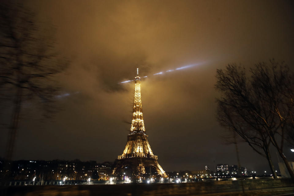 The Eiffel Tower is pictured during the curfew in Paris, Saturday, Jan.16, 2021. All of France is under a stricter curfew starting Saturday at 6 p.m. for at least 15 days to fight the spread of the coronavirus. (AP Photo/Christophe Ena)