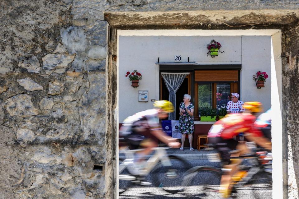 Riders cycle past spectators along the race route during the 13th stage of the Tour de France, in the Jura mountains. (AFP/Getty)