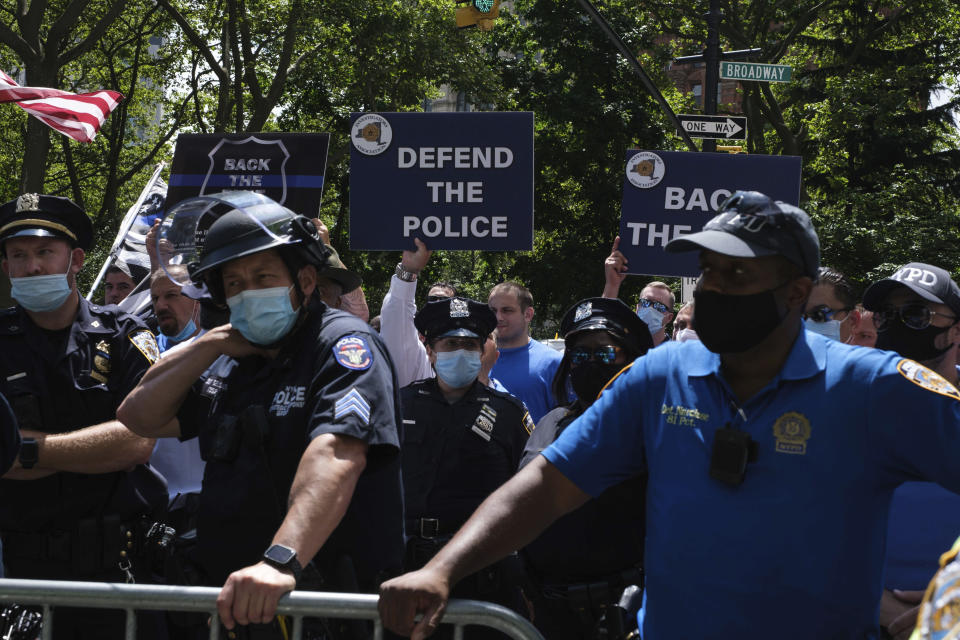 Pro-NYPD demonstrator holds a sign near New York City Hall, Wednesday, July 15, 2020, in New York. (AP Photo/Yuki Iwamura)