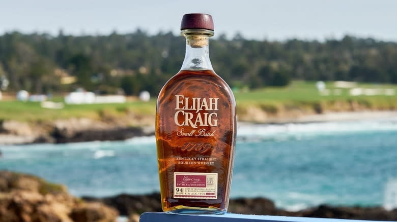 Elijah Craig bottle beside water
