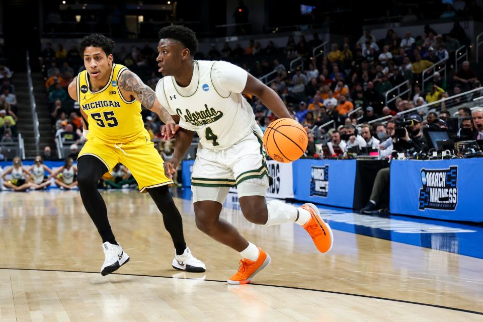 Mar 17, 2022; Indianapolis, IN, USA; Michigan Wolverines guard Eli Brooks (55) defends as Colorado State Rams guard Isaiah Stevens (4) controls the ball in the first half during the first round of the 2022 NCAA Tournament at Gainbridge Fieldhouse.