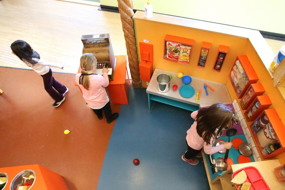 Kids explore how to work a cash register and also work in a kitchen as some of the many activities offered at the Children's Museum of New Hampshire in Dover Nov. 15, 2023.