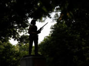 A statue of a Confederate soldier nicknamed Silent Sam is silhouetted on the campus of the University of North Carolina in Chapel Hill, North Carolina, U.S. August 17, 2017. REUTERS/Jonathan Drake