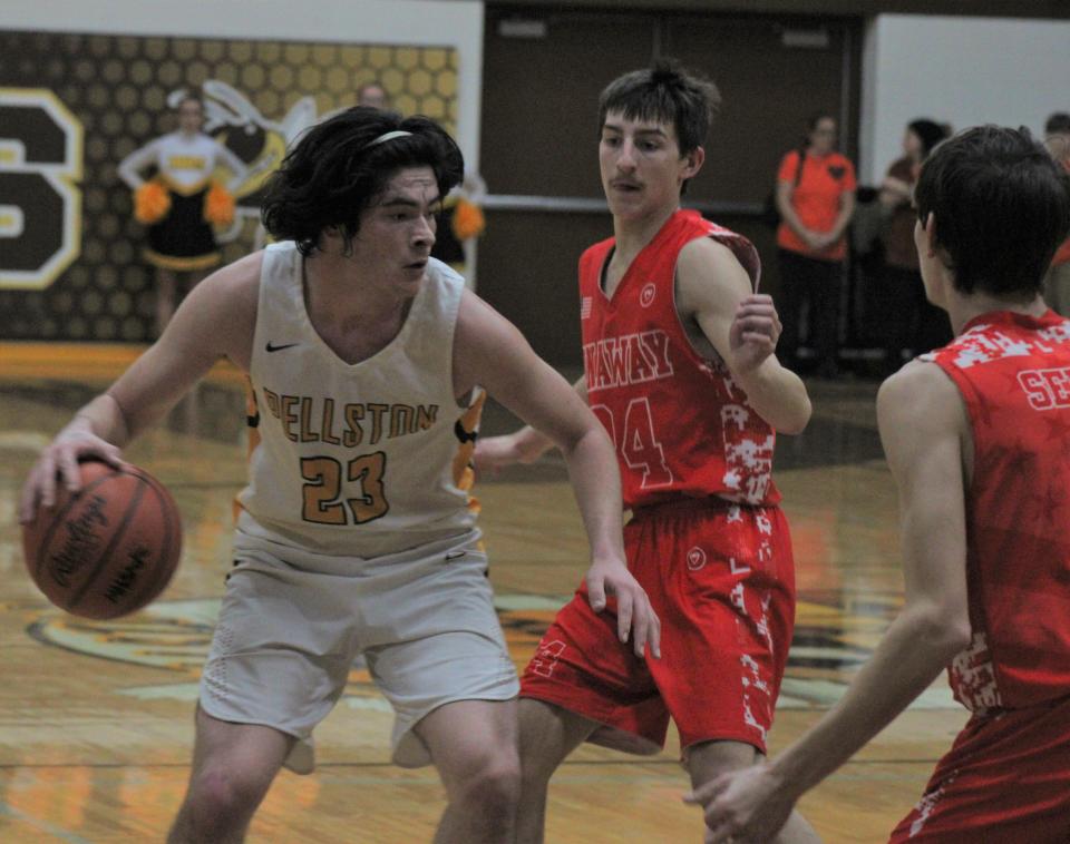 Pellston senior guard Coby Dyer (23) looks to get to the basket while Onaway defenders Austin Veal (24) and Cole Selke (right) swarm during the first half on Tuesday.