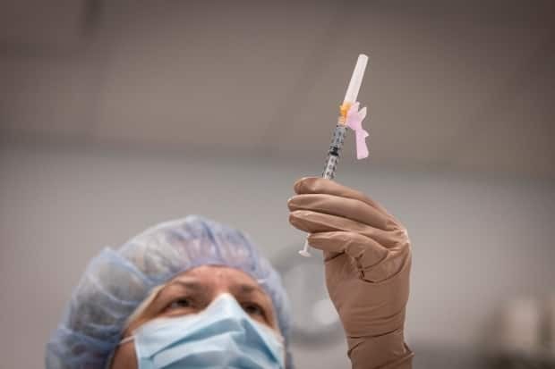 Jasna Stojanovski prepares a dose of the Pfizer-BioNTech COVID-19 vaccine at a clinic for care home workers at St. Michael’s Hospital, in Toronto, on Dec. 22, 2020.