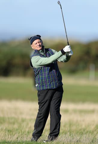 <p>Richard Heathcote/Getty</p> Bill Murray takes his second shot on the 17th hole on Day Three of the Alfred Dunhill Links Championship in 2022.