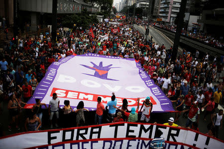 People gather during a protest against a constitutional amendment, known as PEC 55, that limits public spending, in Sao Paulo, Brazil, November 27, 2016. The banner reads "Out Temer", referring to Brazil's President Michel Temer. REUTERS/Nacho Doce