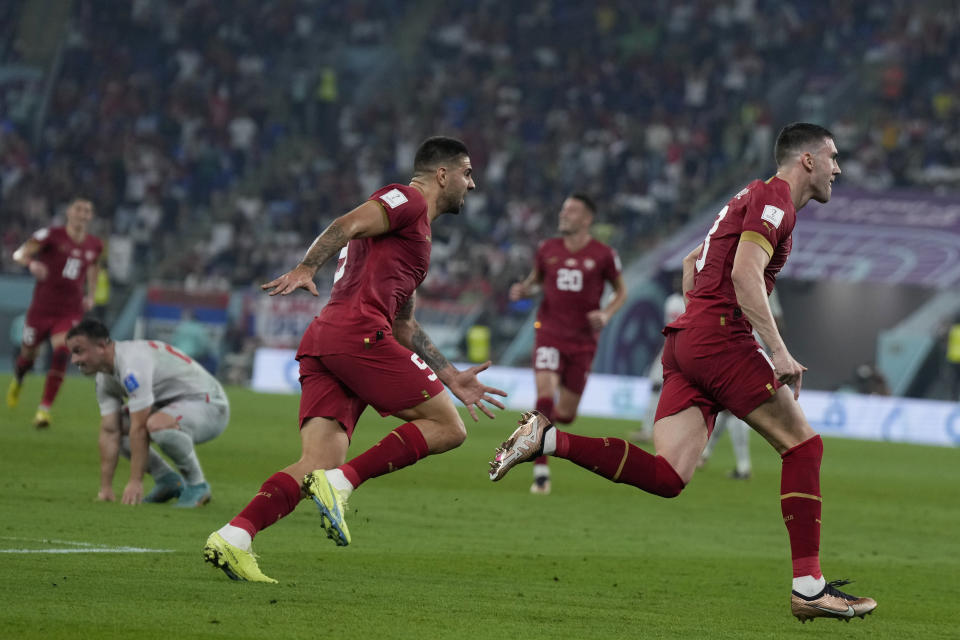 Serbia's Dusan Vlahovic, right, celebrates after scoring his side's second goal during the World Cup group G soccer match between Serbia and Switzerland, in Doha, Qatar, Qatar, Friday Dec. 2, 2022. (AP Photo/Ricardo Mazalan)