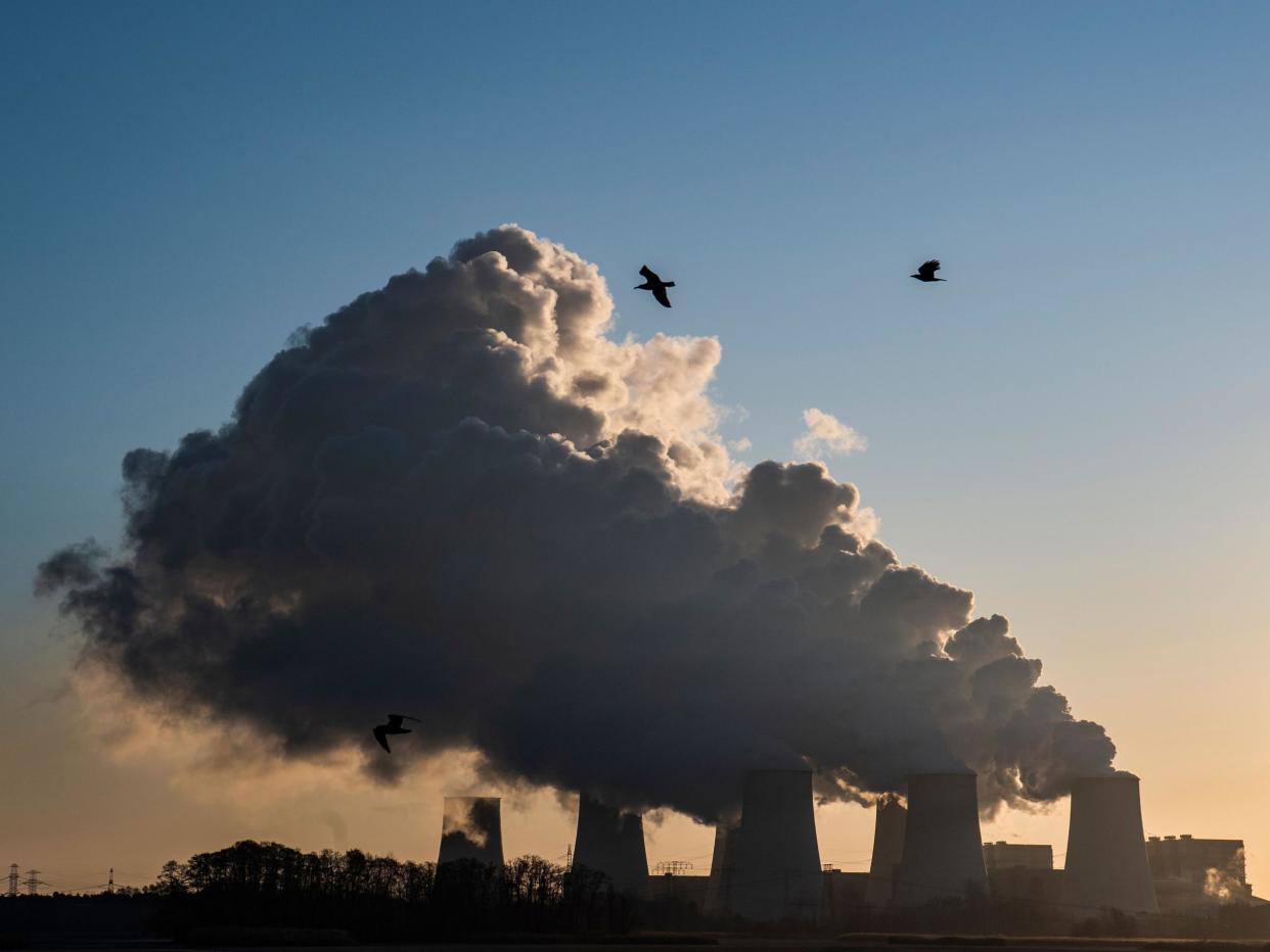 Smoke and vapor rising from the cooling towers and chimneys of the lignite-fired Jaenschwalde Power Station, eastern Germany: AFP via Getty Images