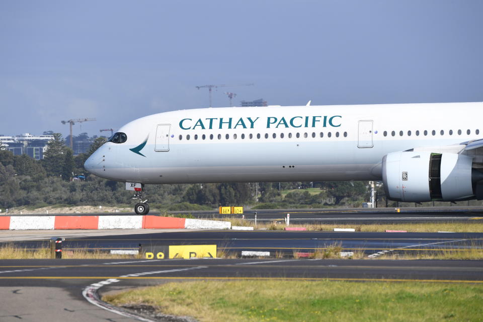 SYDNEY, AUSTRALIA - JULY 11: A Cathay Pacific passenger plane at Kingsford Smith Airport on July 11, 2021 in Sydney, Australia. International arrival numbers will be halved from 14 July as Australian health authorities work to contain the spread of the highly contagious Delta strain of COVID-19 throughout the country. Arrivals into Australia will be reduced to 3,035 people per week until August 31. (Photo by James D. Morgan/Getty Images)