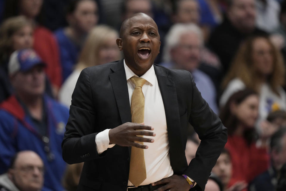 Missouri head coach Dennis talks to his players during the first half of an NCAA college basketball game against Kansas Saturday, Dec. 9, 2023, in Lawrence, Kan. (AP Photo/Charlie Riedel)