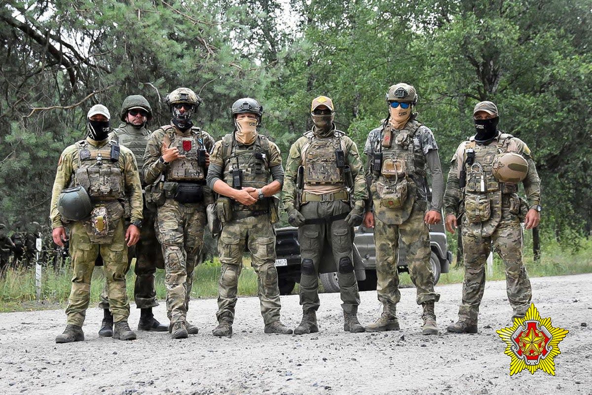In this photo released by the Belarusian Defense Ministry on Thursday, July 20, 2023, soldiers of the Special Operations Forces (SOF) and mercenary fighters from Wagner private military company pose for a photo while the weeklong maneuvers that will be conducted at a firing range near the border city of Brest, Belarus (Belarus' Defense Ministry)