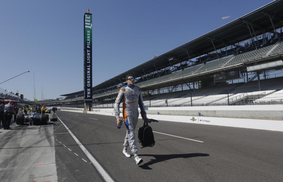 Stefan Wilson, of England, walks to his car before the start of the final practice session for the IndyCar Indianapolis 500 auto race at Indianapolis Motor Speedway, in Indianapolis Friday, May 25, 2018. (AP Photo/AJ Mast)