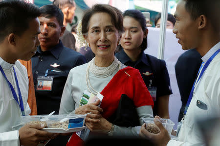 Myanmar's State Counsellor Aung San Suu Kyi tastes locally made dry fish during the Rakhine State Investment Fair at Ngapali beach in Thandwe, Rakhine, Myanmar February 22, 2019. REUTERS/Ann Wang