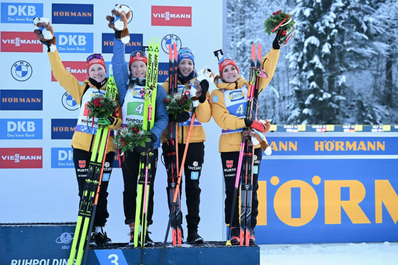 Germany's third-placed team of Janina Hettich-Walz, Sophia Schneider, Franziska Preuss and Hanna Kebinger celebrate on the podium after the Women's 4x6 km relay competition of the Biathlon World Cup in Ruhpolding. Sven Hoppe/dpa