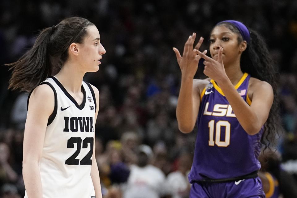 FILE -LSU's Angel Reese reacts in front of Iowa's Caitlin Clark during the second half of the NCAA Women's Final Four championship basketball game April 2, 2023, in Dallas. Iowa and LSU are getting ready to meet again in a rematch of the 2023 national championship game on Monday, April 1, 2024. (AP Photo/Tony Gutierrez, File)