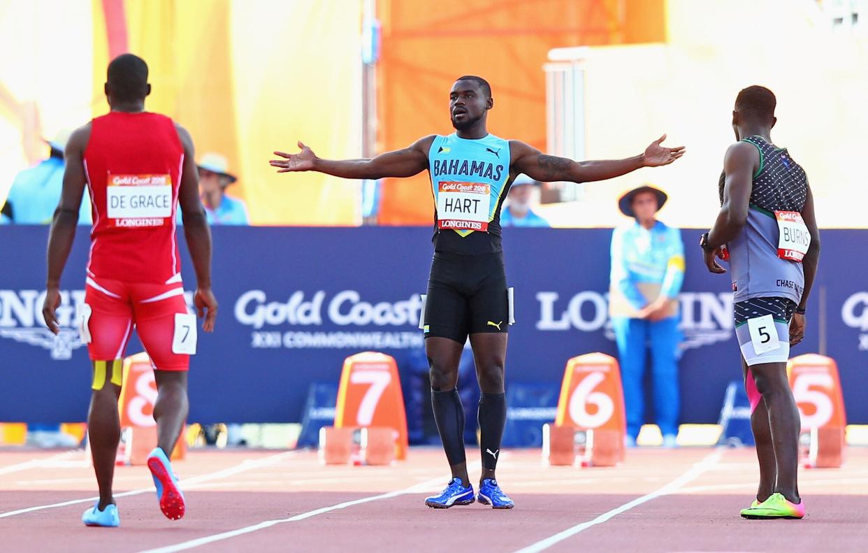 havez Hart of the Bahamas (C) reacts after a false start in the Men's 100 metres heatson day four of the Gold Coast 2018 Commonwealth Games at Carrara Stadium on April 8, 2018 on the Gold Coast, Australia.