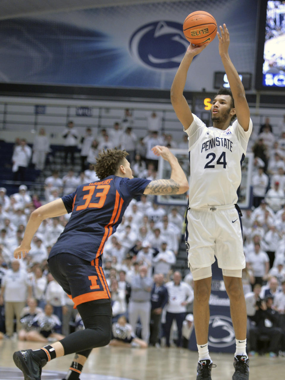 Penn State's Zach Hicks shoots from 3-point range against Illinois' Coleman Hawkins (33) near the end of an NCAA college basketball game Wednesday, Feb. 21, 2024, in State College, Pa. Hicks was fouled and made all three free throws. (AP Photo/Gary M. Baranec)