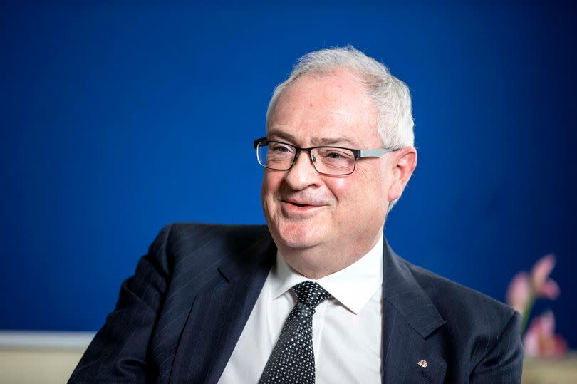 Steve Aiken in shirt and tie smiling